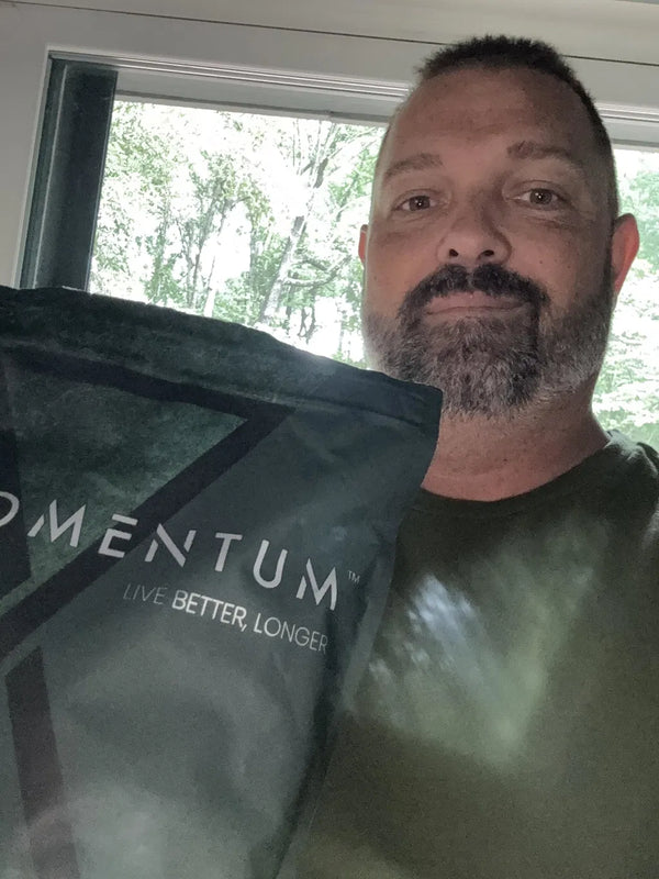 Momentum customer holding a bag of Momentum Shake