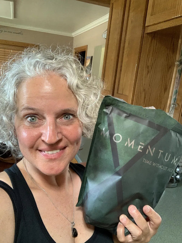 Momentum customer holding a bag of Momentum Shake