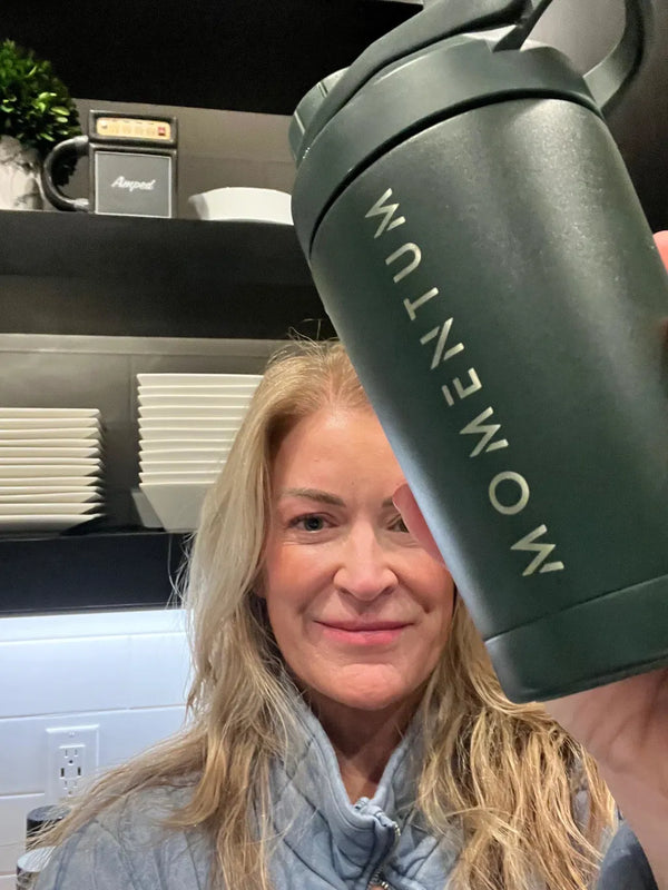Momentum customer holding a bag of Momentum Shake