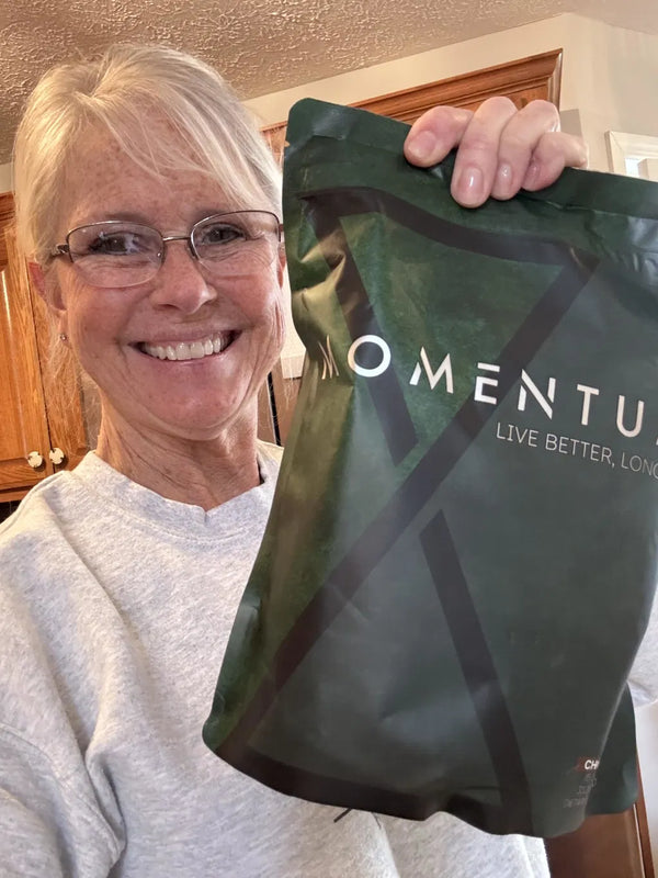 Momentum customer holding a bag of Momentum Shake