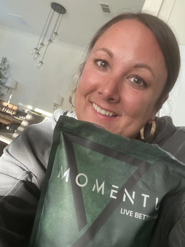 Momentum customer holding a bag of Momentum Shake