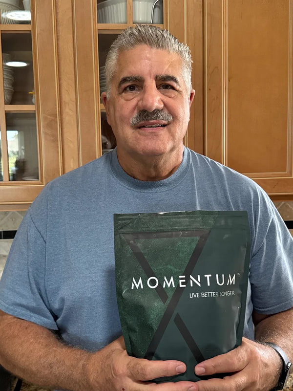 Momentum customer holding a bag of Momentum Shake