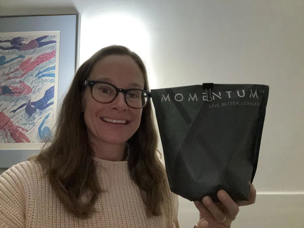 Momentum customer holding a bag of Momentum Shake