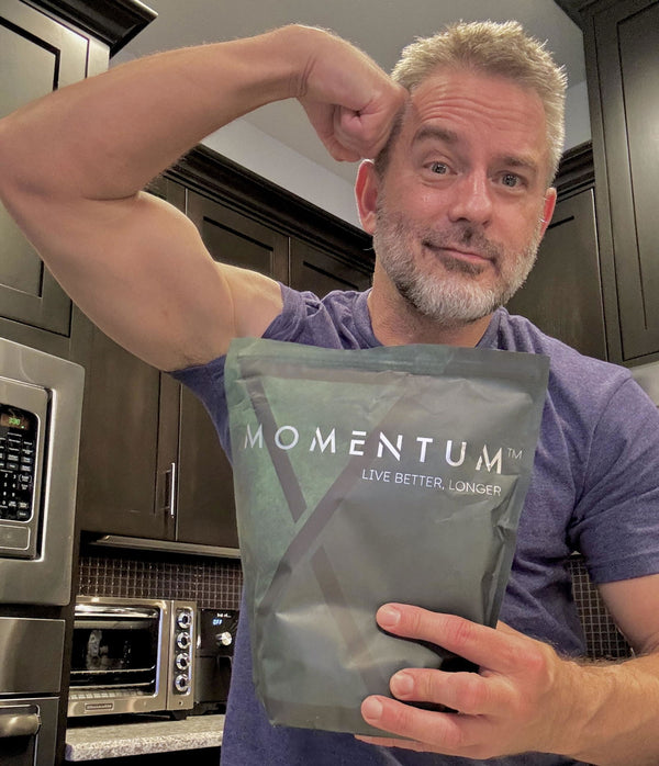 Momentum customer holding a bag of Momentum Shake